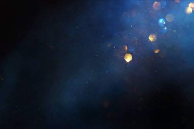 Soyut parıltılı ışıkların arkaplanı. Altın, mavi ve siyah. & Odaklan
