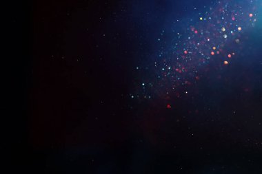 Soyut parıltılı ışıkların arkaplanı. Altın, mavi ve siyah. & Odaklan