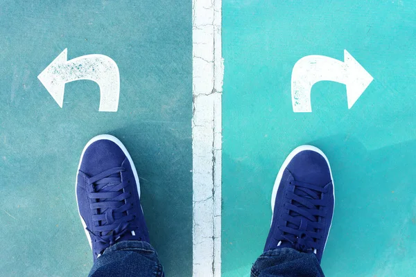 stock image Top view image of young person with sneakers shoes and arrows, concept of choosing direction