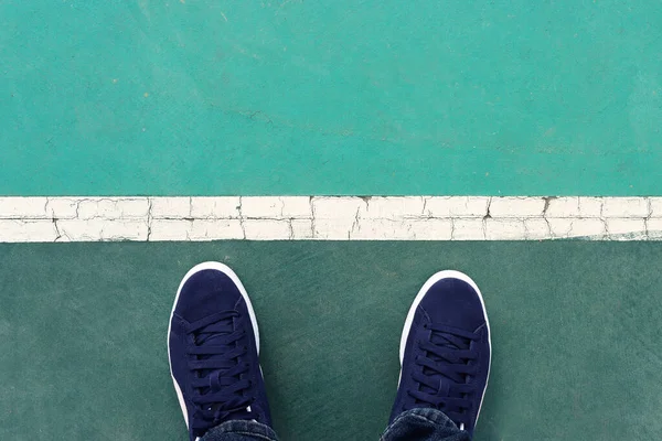 stock image View of sneakers on asphalt road, man moving forward