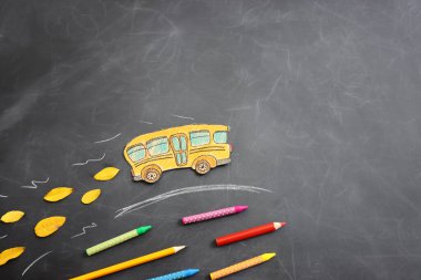 Okul konseptine geri dönelim. Otobüs ve kalemler karatahtanın üzerinde. Üst görünüm