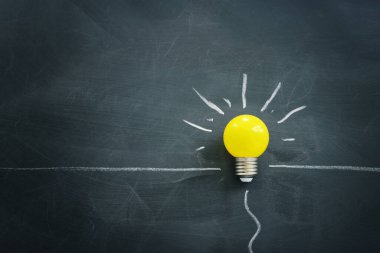 Education concept image. Creative idea and innovation. light bulb metaphor over blackboard background