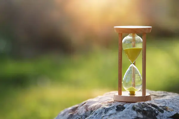 Hourglass in nature. Idea of ecology, time and preserving the earth