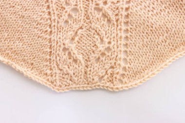 Yünden yapılmış bej örgü süslemesinin arka planı