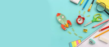 Okul konseptine geri dönelim. Roket ve kalemler mavi arka plan tahtasında. Üst görünüm