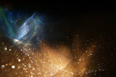 soyut glitter siyah ve altın ışıklar arka plan. de-odaklı