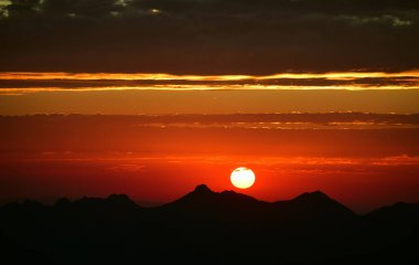 Gün batımında dağların üzerinde bulutlar