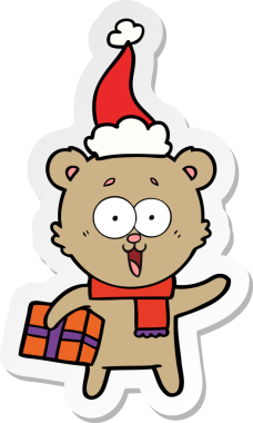 Noel hediyeli orijinal gülen ayıcık Noel Baba şapkası giyiyor.