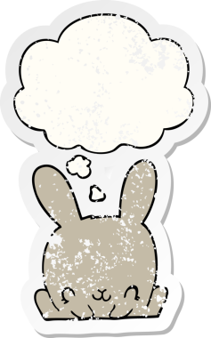 Düşünce baloncuğu olan çizgi film tavşanı insan tarafından çizilmiş yıpranmış bir çıkartma.
