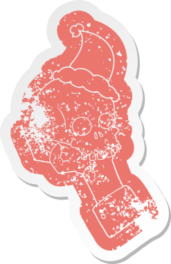 Bir insan tarafından çizilmiş Noel Baba şapkası takan bir el kafatası yapıştırması.