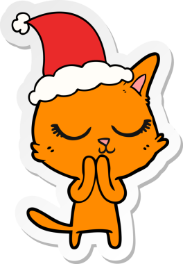 Sakin el çizimi bir insan tarafından çizilmiş Noel Baba şapkası takan bir kedi.