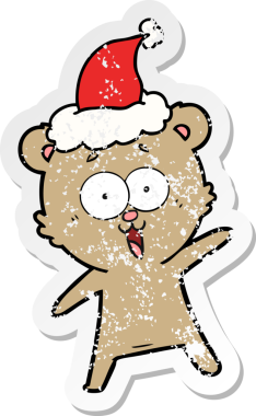 Gülen ayıcığın eli, insan tarafından çizilmiş Noel Baba şapkasının üzgün çıkartması çizilmiş.