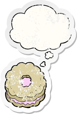Düşünce baloncuklu çizgi film bisküvisi insan tarafından çizilmiş yıpranmış bir çıkartma.
