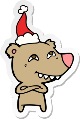 Bir insan tarafından çizilmiş Noel Baba şapkası giymiş bir ayının el çizimi karikatürü.