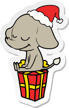 Bir insan tarafından çizilmiş Noel Baba şapkası takan gülümseyen bir filin el yazısı.