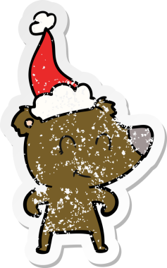 Kadın ayı eli, bir insan tarafından çizilmiş Noel Baba şapkasının çizilmiş çıkartması.