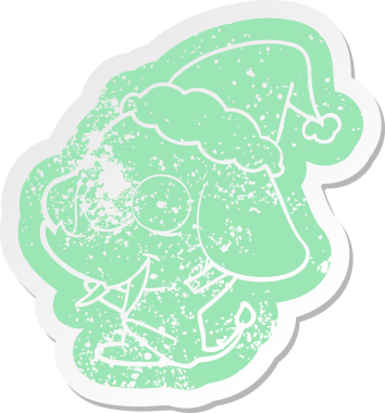 Mutlu karikatür. Bir insan tarafından çizilmiş Noel Baba şapkası takan bir filin hüzünlü çıkartması.