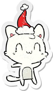 Bir insan tarafından çizilmiş Noel Baba şapkası takan mutlu bir kedinin çizilmiş el yazısı.