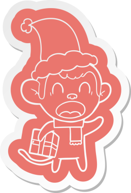 Noel hediyesi taşıyan bir maymunun insan tarafından çizilmiş Noel Baba şapkasıyla tuhaf bir karikatür çıkartması.