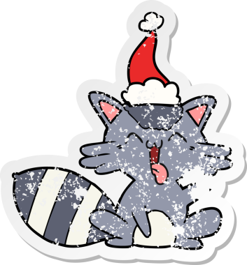 Sevimli bir el, bir insan tarafından çizilmiş Noel Baba şapkası takan bir rakunun üzgün çıkartması çizilmiş.