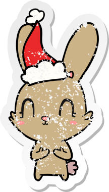 Bir insan tarafından çizilmiş Noel Baba şapkası takan bir tavşan çizilmiş.