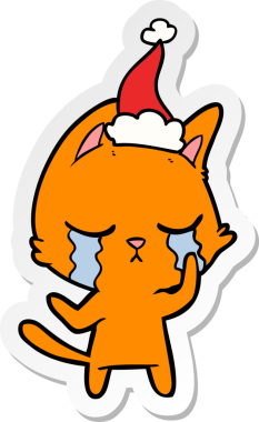Ağlayan el çizimi bir insan tarafından çizilmiş Noel Baba şapkası takan bir kedi.