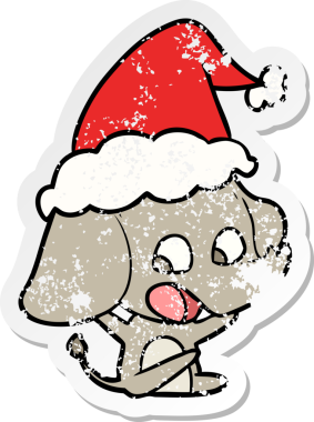 Sevimli el, insan tarafından çizilmiş Noel Baba şapkası giymiş bir fil çıkartması çizmiş.