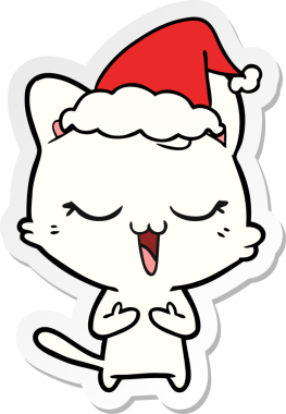 Bir insan tarafından çizilmiş Noel Baba şapkası takan bir kedinin çizilmiş mutlu el yazısı.