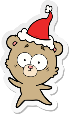 Endişeli ayı eli bir insan tarafından çizilmiş Noel Baba şapkasının çıkartması.