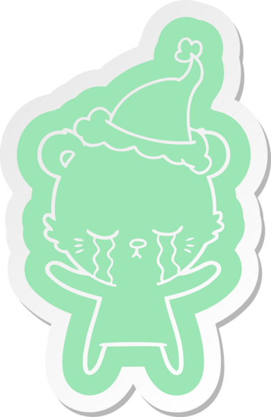 Bir insan tarafından çizilmiş Noel Baba şapkası giyen bir kutup ayısının garip çizgi film çıkartması.