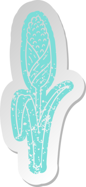 Bir insan tarafından çizilmiş mısır koçanının üzerinde eski bir karikatür çıkartması var.