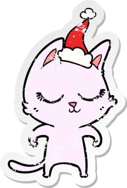 Sakin bir el, kederli bir insan tarafından çizilmiş Noel Baba şapkası takan bir kedinin çıkartması.