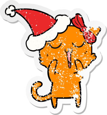 Bir insan tarafından çizilmiş Noel Baba şapkası takan bir kedinin çizilmiş el yazısı.