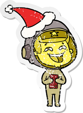 Bir insan tarafından çizilmiş Noel Baba şapkası giymiş, gülen bir astronotun çizilmiş el yazısı.