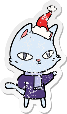 Bir insan tarafından çizilmiş Noel Baba şapkası takan kedinin kederli çıkartması.