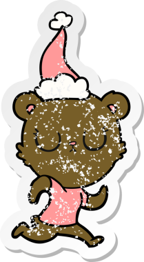 Huzurlu bir el, bir insan tarafından çizilmiş Noel Baba şapkasıyla koşan bir ayının kederli çıkartması.