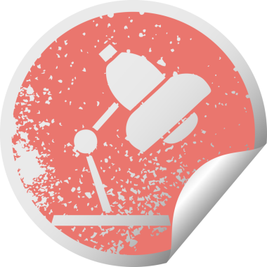 Bir insan tarafından çizilmiş bir masa lambası sembolünün derisi soyulmuş dairesel etiket.