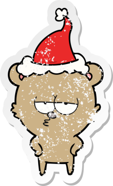 Sıkılmış ayı eli bir insan tarafından çizilmiş Noel Baba şapkasının sıkıntılı çıkartması.