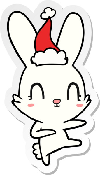 Bir insan tarafından çizilmiş Noel Baba şapkasıyla dans eden bir tavşanın çizilmiş şirin el yazısı.