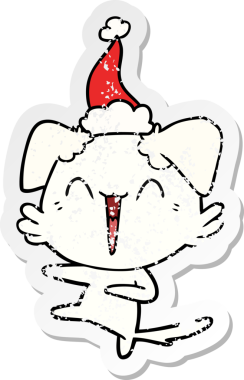 Mutlu dans eden köpek eli bir insan tarafından çizilmiş Noel Baba şapkası çizilmiş.