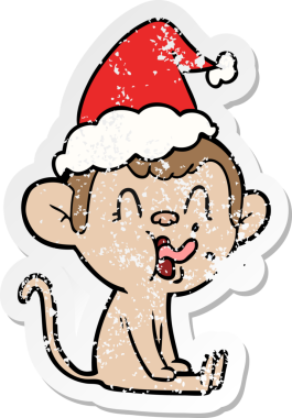 Çılgın el, insan tarafından çizilmiş Noel Baba şapkası takan bir maymunun kederli çıkartması.