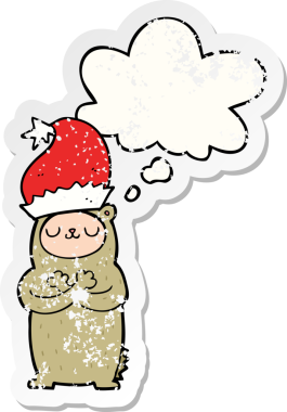 Düşünce baloncuklu Noel şapkası takan çizgi film ayısı insan tarafından çizilmiş yıpranmış bir çıkartma.