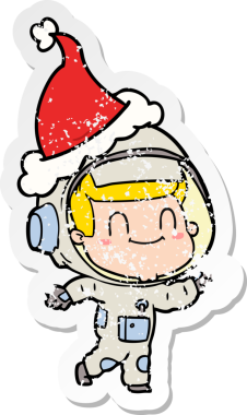 Mutlu el, insan tarafından çizilmiş Noel Baba şapkası giyen astronot bir adamın sıkıntılı çıkartmasını çizdi.