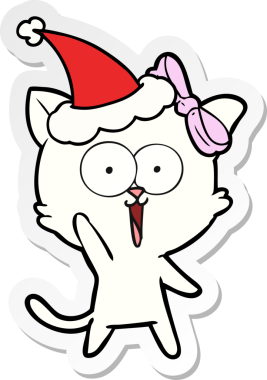 Bir insan tarafından çizilmiş Noel Baba şapkası takan bir kedinin el yazısı.