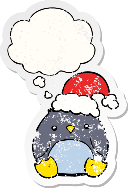 Düşünce baloncuklu Noel şapkası takan sevimli penguen dertli bir insan tarafından çizilmiş bir çıkartma.