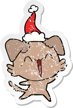 Mutlu, küçük köpek eli, insan tarafından çizilmiş Noel Baba şapkası çizilmiş.