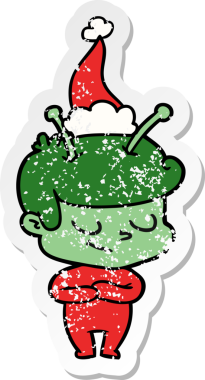 Arkadaş canlısı el, bir insan tarafından çizilmiş Noel Baba şapkası takan bir uzay adamının üzgün çıkartması.