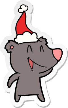 Gülen ayı eli bir insan tarafından çizilmiş Noel Baba şapkasının çıkartması.