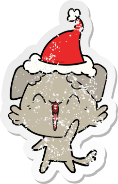 Mutlu, küçük köpek eli, insan tarafından çizilmiş Noel Baba şapkası çizilmiş.