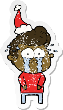 Bir insan tarafından çizilmiş, ağlayan, Noel Baba şapkası takan, kederli bir adamın çıkartması.